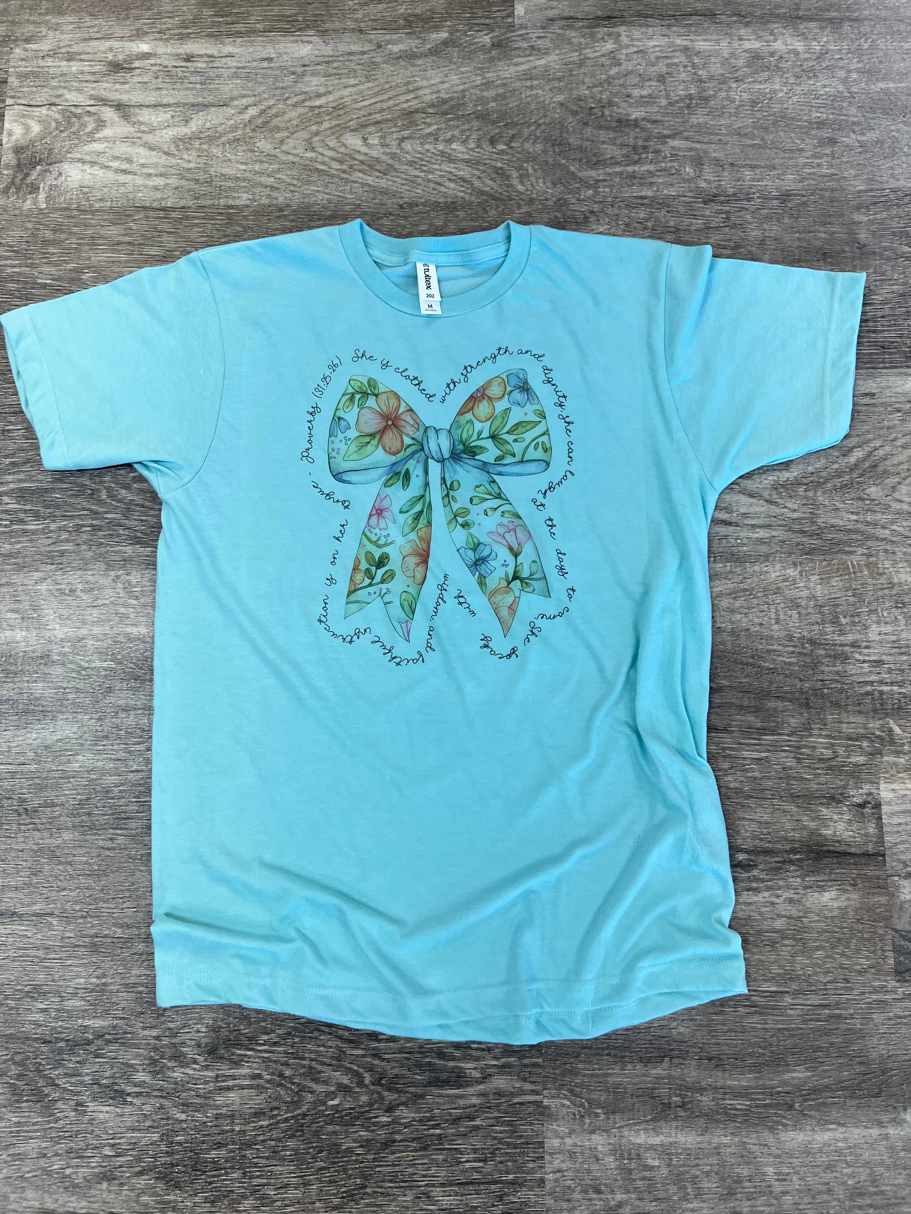 She Is Clothed with Strength Floral Bow On Purist Blue Tee